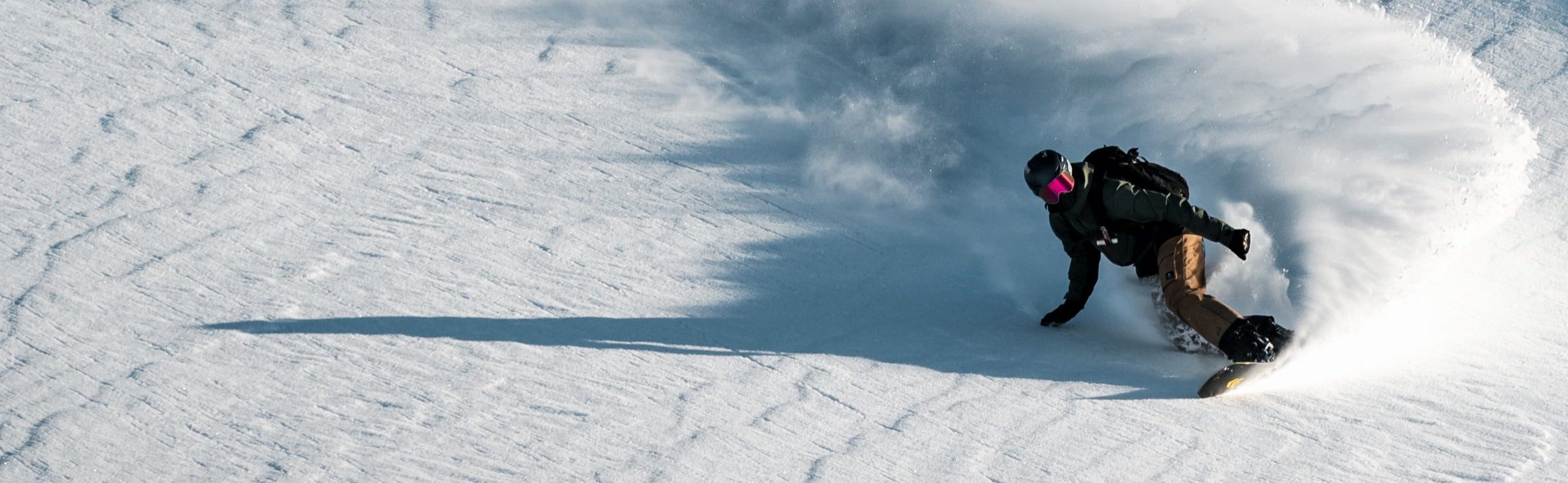 Snowboarder riding the Borealis Artefact Freeride Snowboard